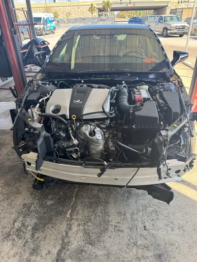 The engine and transaxle back in the Lexus engine bay after the collision center finished the structural repair