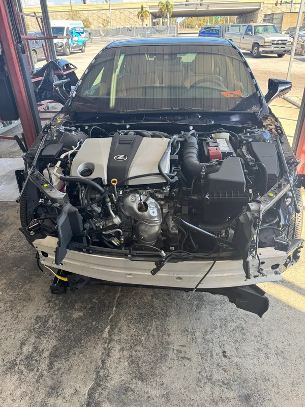 The engine and transaxle back in the Lexus engine bay after the collision center finished the structural repair