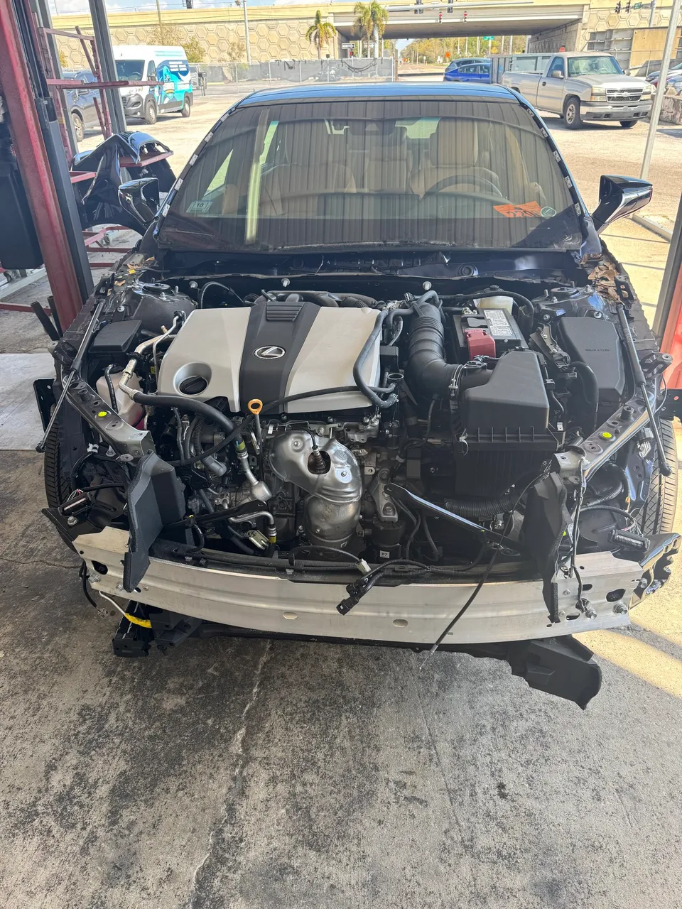 The engine and transaxle back in the Lexus engine bay after the collision center finished the structural repair