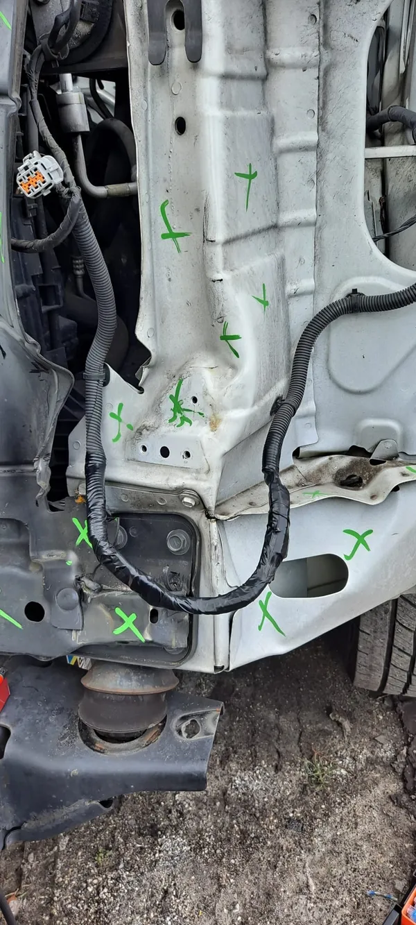 The same run repaired, the wires back inside black protective loom and routed along the structural rail