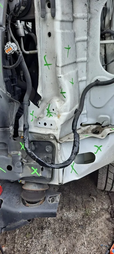 The same run repaired, the wires back inside black protective loom and routed along the structural rail