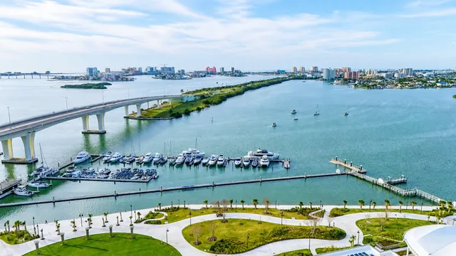 Aerial view of Clearwater Harbor, with the Memorial Causeway bridge crossing toward Clearwater Beach and boats moored at the downtown marina