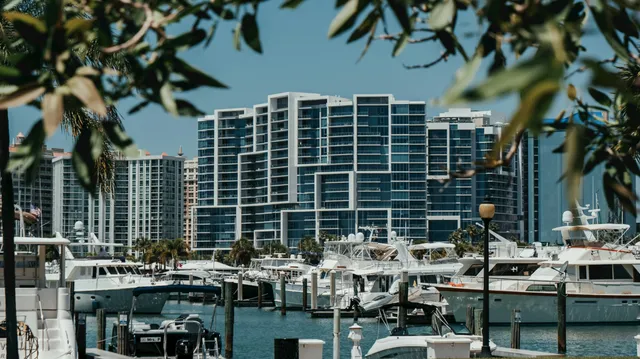 Yachts moored at the Sarasota bayfront marina with downtown condominium towers rising behind them
